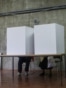 Serbia - People votes in a voting booth at a polling station in Belgrade on June 21, 2020
