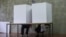 Serbia - People votes in a voting booth at a polling station in Belgrade on June 21, 2020