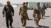 U.S. and Iraqi Army officers walk inside a base at Qayyara, west of Mosul.