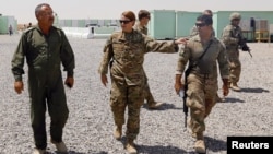 U.S. and Iraqi Army officers walk inside a base at Qayyara, west of Mosul.