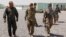 U.S. and Iraqi Army officers walk inside a base at Qayyara, west of Mosul.