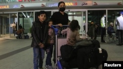 Iraqi migrants who voluntarily registered for an evacuation flight from Belarus arrive in Irbil on November 18.
