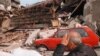 Serbia -- An elderly resident sits devastated after his and the homes of four other families were totally destroyed following overnight NATO air attacks in the Belgrade area, 30Apr1999