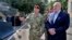 Belarusian President Alyaksandr Lukashenka (right) inspects police vehicles as he visits the Interior Ministry special forces base in Minsk on July 28. 