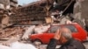 Serbia -- An elderly resident sits devastated after his and the homes of four other families were totally destroyed following overnight NATO air attacks in the Belgrade area, 30Apr1999