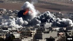 Smoke and flames rise following an apparent U.S.-led coalition air strike on Kobani on October 22.