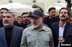 Iranian Parliament Speaker Mohammad Baqer Qalibaf (center) visits the Imam Ali Shrine in the holy city of Najaf in Iraq on August 21.