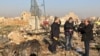 TV journalists stand amid the wreckage after a Ukrainian plane carrying 176 passengers crashed near Imam Khomeini airport in the Iranian capital Tehran early in the morning on January 8, 2020, killing everyone on board.