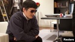 China -- Blind activist Chen Guangcheng speaks into a phone in Beijing, 02May2012