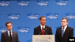 U.S. President Barack Obama is flanked by French President Nicolas Sarkozy (left) and British Prime Minister Gordon Brown on the second day of the G-20 summit in Pittsburgh.