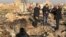 TV journalists stand amid the wreckage after a Ukrainian plane crashed in Iran, possibly downed by a missile.