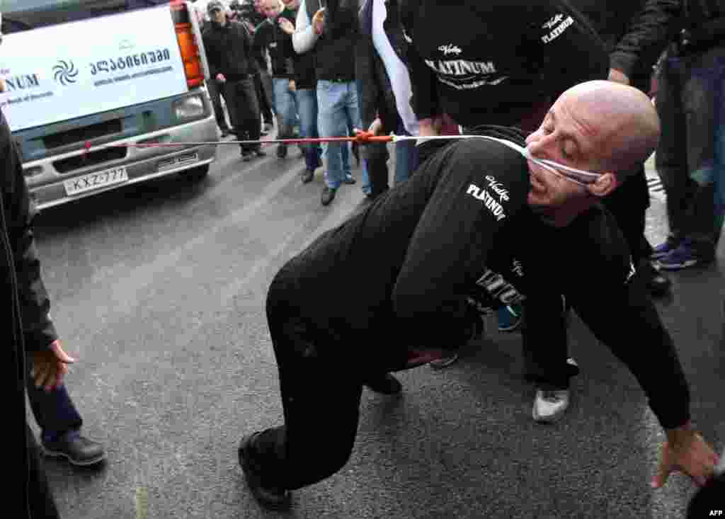 Lasha Pataraia pulls an 8-ton truck with his ear during an event in the Georgian city of Rustavi, outside Tbilisi, on November 29. The 32-year-old Georgian athlete broke a Guinness record after he managed to pull the truck with his ear for 21.5 meters. (AFP/Vano Shlamov)