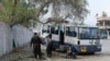 Afghan policemen inspect the scene after a deadly blast in Jalalabad on March 19. 