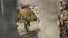 Afghan soldiers near a hole in a wall made to rescue people from the Shamshad TV building after a deadly attack in Kabul on November 7.