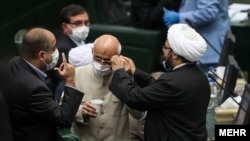 Members of the new Iranian parliament wearing masks. Undated