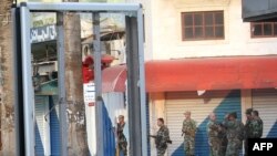 Syrian soldiers patrol the port city of Latakia on March 27.