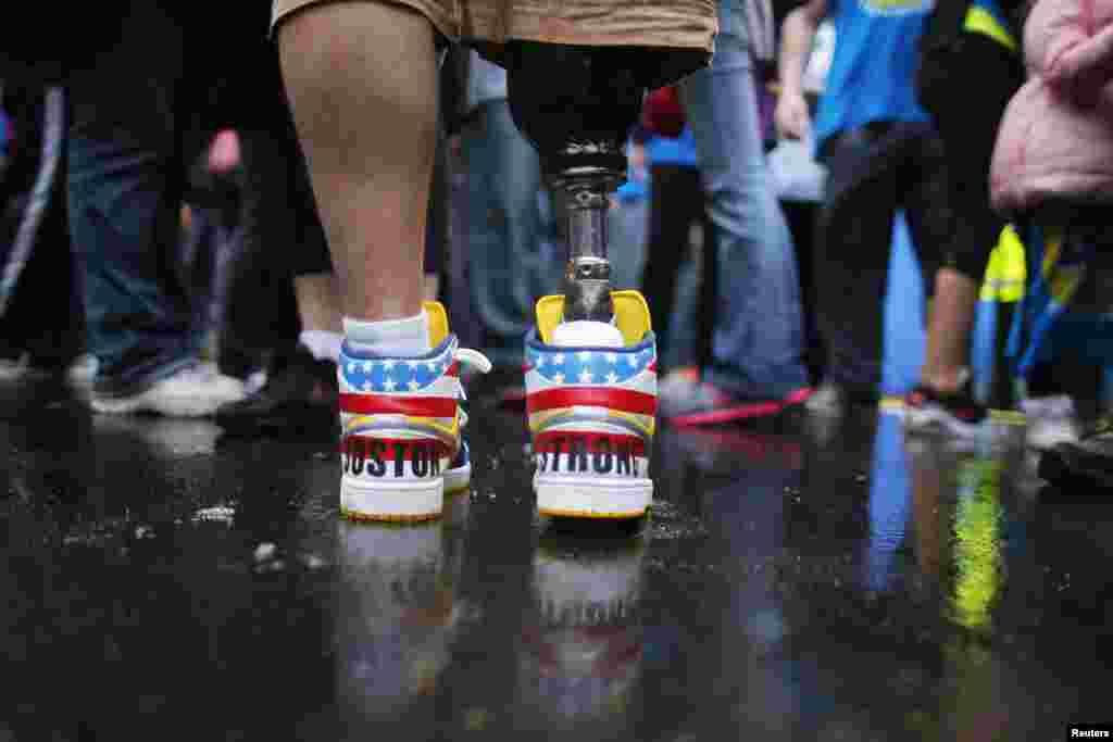 The shoes of bombing survivor J.P. Norden read &quot;Boston Strong&quot; as he stands at the finish line on the first anniversary of the attack in Boston on April 15, 2014.&nbsp;