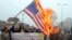 Pakistan -- Pakistani demonstrators shout slogans beside a burning US flag during a protest in Multan on 03Jan2013