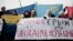 Demonstrators hold placards reading "Crimea is Ukraine" during a rally on Independence Square in central Kyiv in March. 