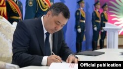 Kyrgyz President Sadyr Japarov signing the new bill into law on May 5. 