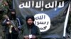 An image made from a video released by the Islamic State (IS) on January 27 purportedly showing Hafiz Said Khan, center, head of IS in Pakistan and Afghanistan, at an undisclosed location along the border.