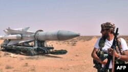 Libya -- A Libyan NTC fighter looks at a Scud missile at Al-Burkan base (codenamed K9), 70 kms from Bani Walid, southeast of Tripoli, 02Sep2011