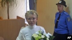 Yulia Tymoshenko, not a hair out of place, stands inside the court hearing room in Kyiv on August 10, after spending another night in the capital's Lukyanovsky detention center.