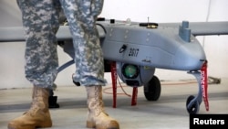 A soldier stands in front of a "Shadow" Unmanned Aerial System during an official presentation by the German and U.S. Unmanned Aerial Systems (UAS) at the U.S. military base in Vilseck-Grafenwoehr in October.