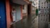 A woman stands on a flooded street in Kherson after the Nova Kakhovka dam breached on June 6. 