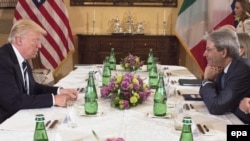 Italian Prime Minister Paolo Gentiloni (right) speaks with U.S. President Donald Trump during their meeting at Villa Taverna in Rome on May 24.