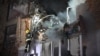 Rescuers extinguish a fire in an apartment building destroyed by a Russian missile attack in Kharkiv early on May 31 amid the Russian invasion in Ukraine.