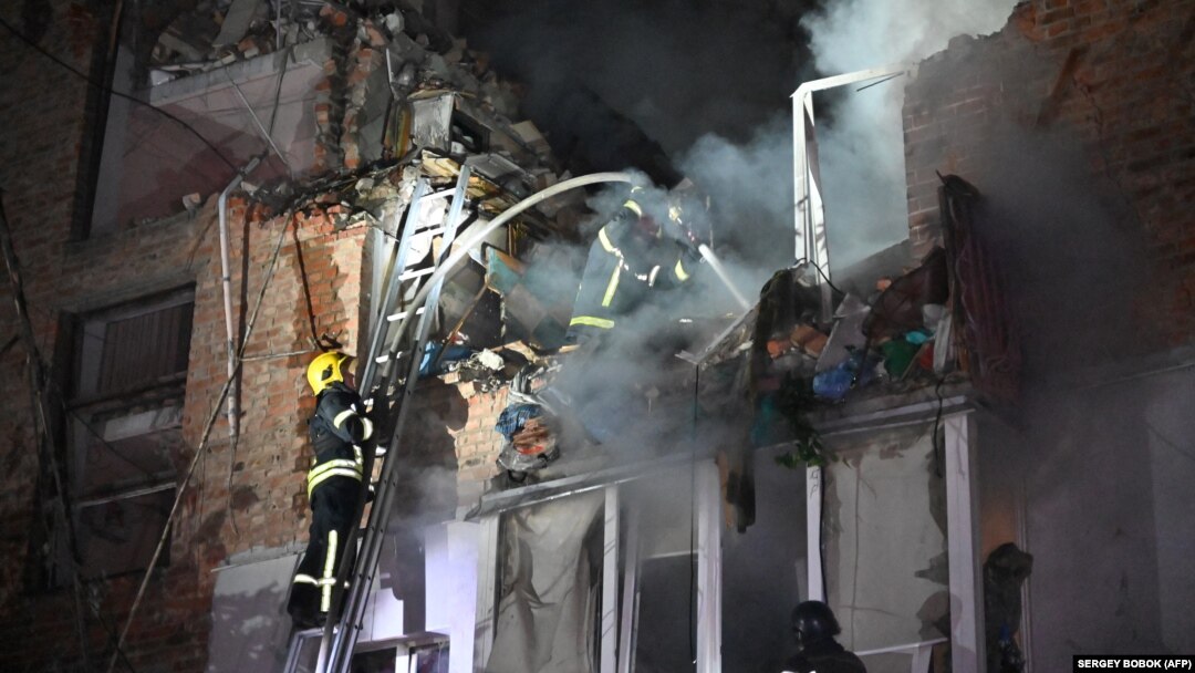 Rescuers extinguish a fire in an apartment building destroyed by a Russian missile attack in Kharkiv early on May 31 amid the Russian invasion in Ukraine.