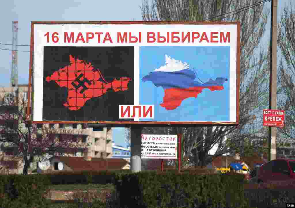 A man walks past a poster in Sevastopol on March 10 depicting a referendum called by Crimea&rsquo;s pro-Russian authorities as a choice between Nazism and Russia. The March 16 referendum, which did not offer the option of Crimea retaining its status quo, was declared illegal by Kyiv and not recognized by most countries. Voters overwhelmingly opted to rejoin with Russia in a vote that was widely dismissed as falsified. &nbsp;