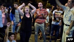 Armenia -- Armenian opposition supporters shout and gesture in front of riot police blocking the streets to Erebuni police station seized by gunmen - supporters of fringe jailed opposition leader  Zhirayr Sefilian - in Yerevan early, July 28, 2016