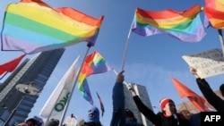 Gay rights activists take part in a rally against homophobic laws in Moscow in 2012.