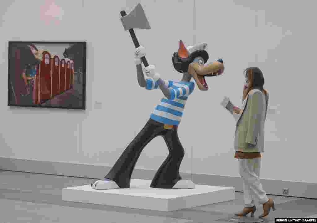 A visitor passes artwork by Tommy Cash of Estonia.