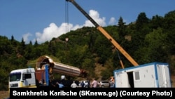 The minaret from a mosque in Chela, Georgia, being unloaded following a customs inspection in Tbilisi. 