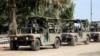 Soldați israelieni patrulează cu vehicule militare la granița Israelului cu Gaza, 10 octombrie 2023.