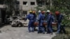 Rescue workers in Kyiv remove a body from a building hit in a massive Russian drone and missile attack on the Ukrainian capital. 