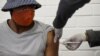 A volunteer receives an injection from a medical worker during the country's first human clinical trial for a potential vaccine against the novel coronavirus, at Baragwanath Hospital in Soweto, South Africa, June 24, 2020. REUTERS/Siphiwe Sibeko/File Phot