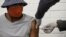 A volunteer receives an injection from a medical worker during the country's first human clinical trial for a potential vaccine against the novel coronavirus, at Baragwanath Hospital in Soweto, South Africa, June 24, 2020. REUTERS/Siphiwe Sibeko/File Phot