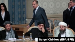 FILE: Russian Foreign Minister Sergei Lavrov passes members of the Taliban delegation during a meeting on Afghan peace in Moscow (November, 2018).