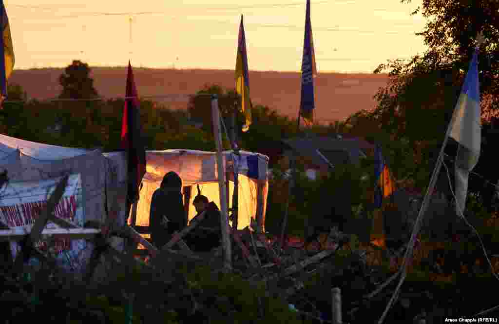Guards at the entrance to the camp. After apparently forcing Kyiv’s hand in March, the activists now appear emboldened to demand more from a government they see as ineffectual. On May 26, the activists announced plans to begin a new stage of activity "within two weeks," targeting Russian-linked businesses in Ukraine. 