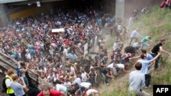 Attendees of the "Love Parade" fleeing after the deadly panic broke out on July 24.