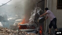 An Iraqi man tries to put out a car fire as Iraqi Counter-Terrorism Services advance toward Mosul's western Rifai neighborhood during their ongoing offensive against Islamic State (IS) fighters on May 16. 