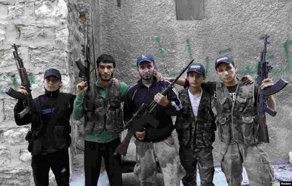 Five brothers who are members of a rebel group called Martyr Al-Abbas pose for a picture in Aleppo, Syria. The brothers said the group, which consists of other members, is operating under the Free Syrian Army and was first established in the memory of their brother Abbas Sheikh Yasine, who died in fighting against government forces. (Reuters/Muzaffar Salman)