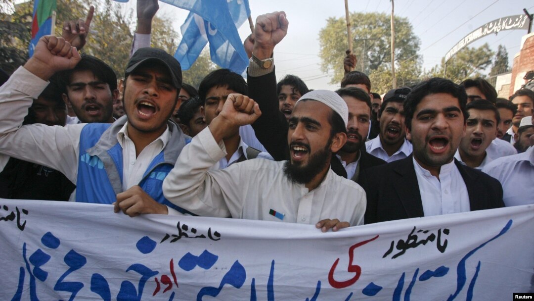 Student supporters of Jamaat-e Islami hold a banner and shout anti-American slogans in Peshawar on November 29 during a protest over the NATO air strikes three days earlier.