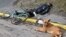 UKRAINE – A dog lies next to a body of a man in a street in the town of Bucha, not far from the Ukrainian capital of Kyiv on April 3, 2022