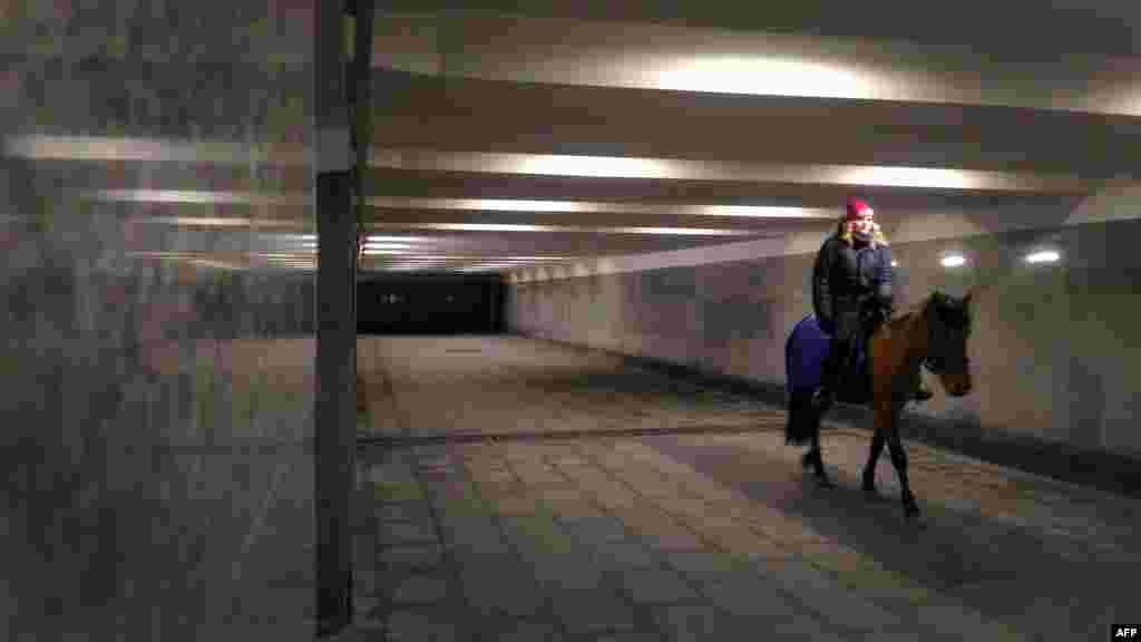 A woman rides a horse in an underground passage in Moscow. (AFP/Vasily Maksimov)