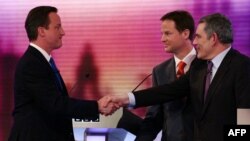 Conservative Party leader David Cameron (left) shakes hands with Prime Minister, and leader of the ruling Labour Party, Gordon Brown (right), with Liberal Democrats leader Nick Clegg behind, after the live TV debate in Birmingham on April 29.